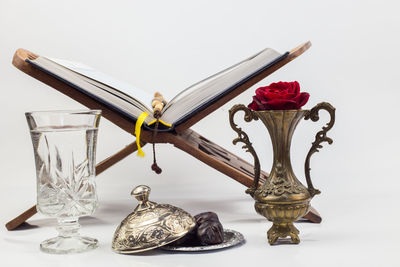 Close-up of figurine on table against white background