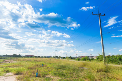 Electricity pylon on field against sky