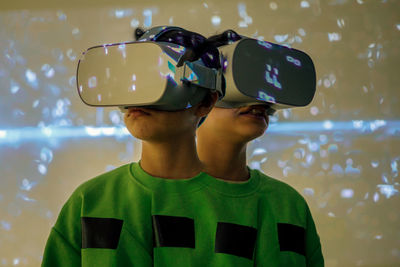 Young girl playing with virtual reality glasses, multiple exposure