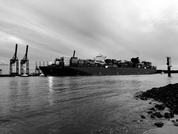 Commercial dock by sea against sky