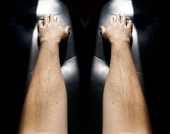 Low section of man legs against black background