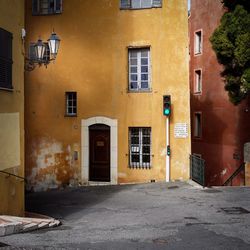 Empty alley amidst houses in town