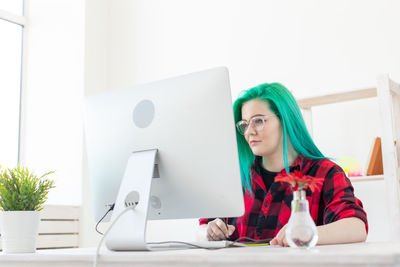 Portrait of woman working on table