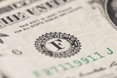 Close-up of bitcoin on paper currency