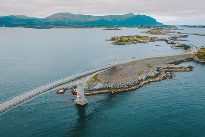 Aerial view of bridge by sea against sky