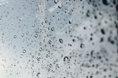 Full frame shot of raindrops on glass window