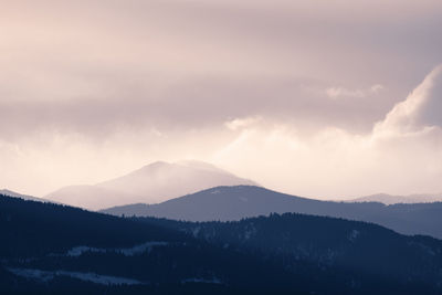 Scenic view of silhouette mountains against sky during sunset