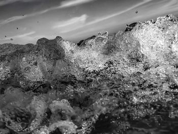 Close-up of water splashing against sky