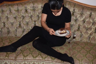 High angle view of man sitting on table