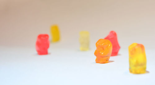 Close-up of multi colored candies against white background