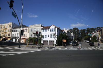City street by buildings against sky
