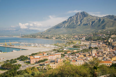 Townscape by sea against sky