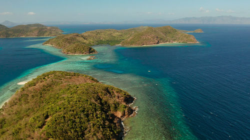 Tropical islands with blue lagoons, coral reef and sandy beach, aerial view. palawan, philippines