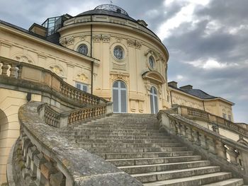 Low angle view of building against cloudy sky