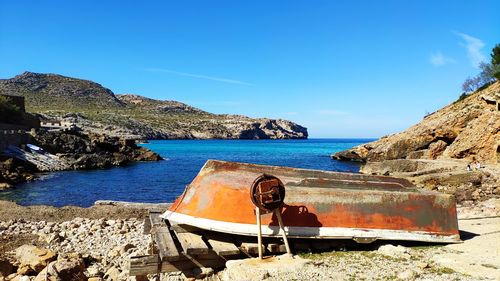 Scenic view of beach against blue sky