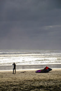 People on beach against sky