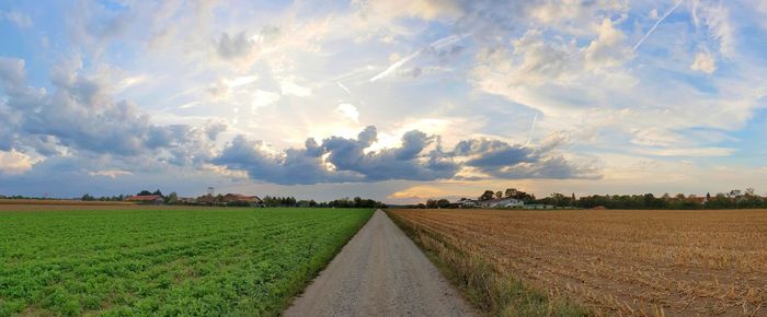 Panoramic shot of agricultural field against sky