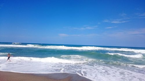 Scenic view of sea against blue sky