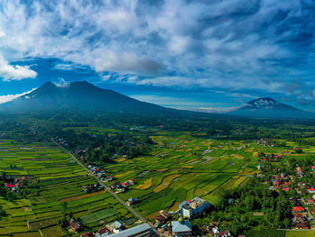 Aerial view of townscape against sky, marapi mount and singgalang mount