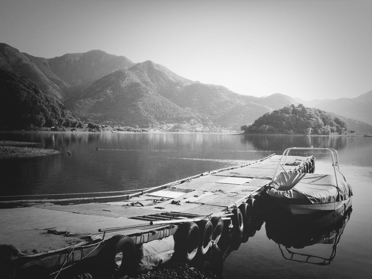 mountain, water, mountain range, lake, tranquil scene, tranquility, scenics, nautical vessel, beauty in nature, nature, boat, reflection, transportation, moored, non-urban scene, river, sky, idyllic, lakeshore, clear sky