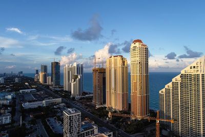 Panoramic view of buildings in city against sky