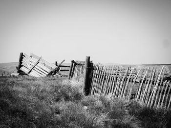 Abandoned structure on field against clear sky