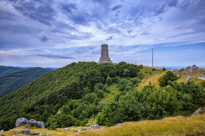 Scenic view of trees and shipka monument against sky