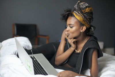 Young woman looking at her laptop