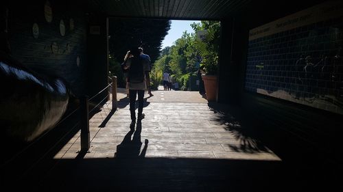 Rear view of man walking on walkway