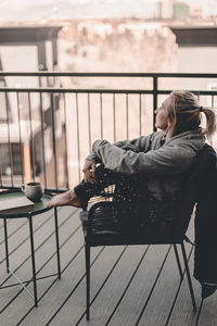 Woman sitting on railing