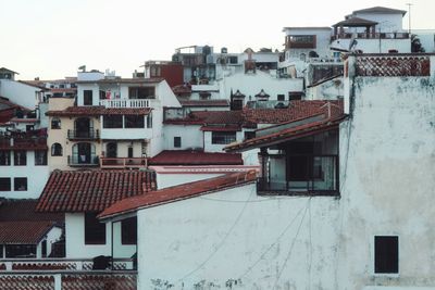 Houses in town against sky