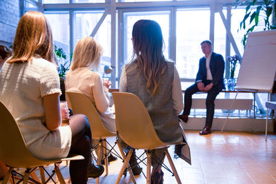 Rear view of people sitting on chair