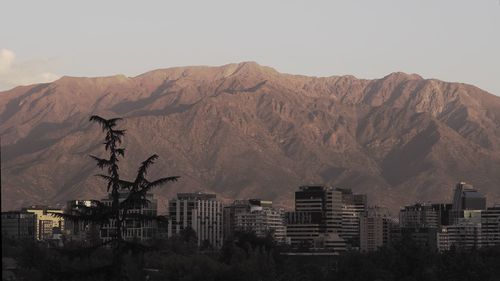 Buildings in city against clear sky