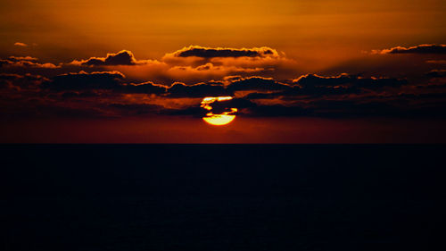 Scenic view of sea against romantic sky at sunset