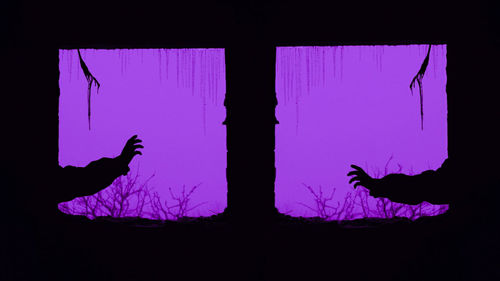 Silhouette people against blue sky seen through window