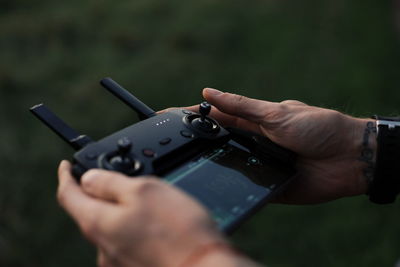 Cropped hands using drone remote control