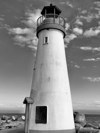 Low angle view of lighthouse by sea against sky