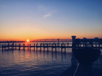 Pier on sea at sunset