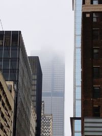 Low angle view of skyscrapers against clear sky