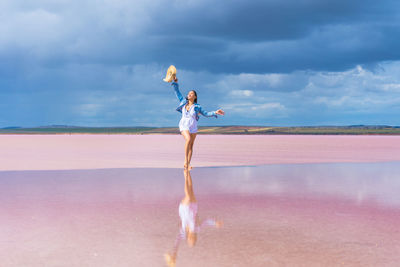 Man standing on beach against sky