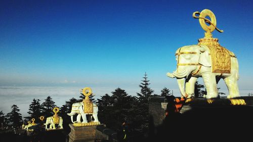 Statue against blue sky