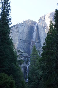 Low angle view of waterfall against sky