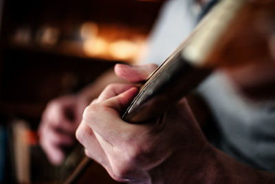 Cropped image of musician playing acoustic guitar