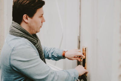 Young man entering house