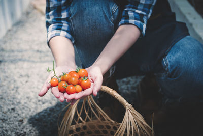 Midsection of man holding strawberry