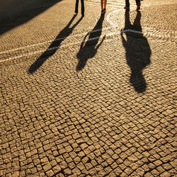 Shadow of people on footpath