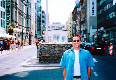 Portrait of man standing on street in city