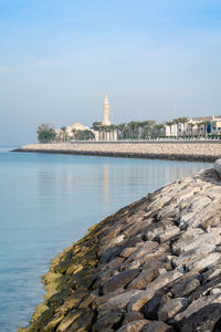 View of sea and buildings against sky