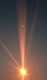 Scenic view of vapor trails in sky during sunset