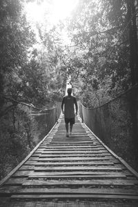 Rear view of man walking in forest